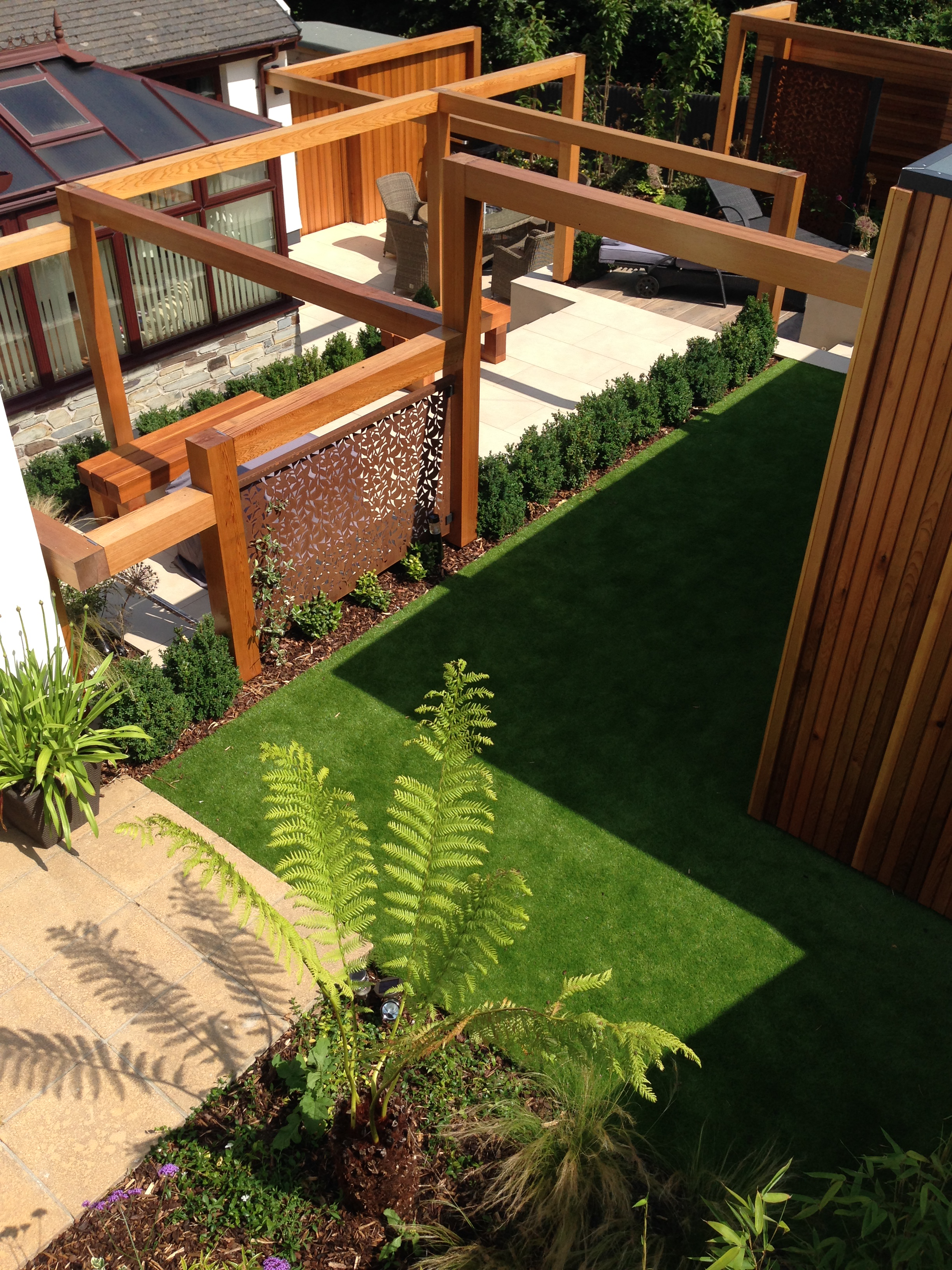 Looking down into the new contemporary garden with view of the tree fern and artificial grass
